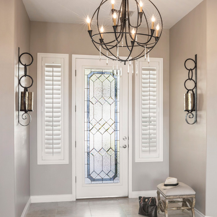 White sidelights on each side of the entrance door in a foyer.