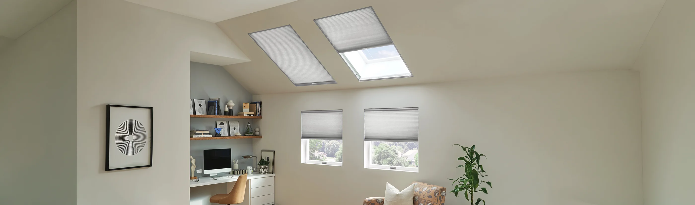 gray cellular shades in two skylight windows within an office