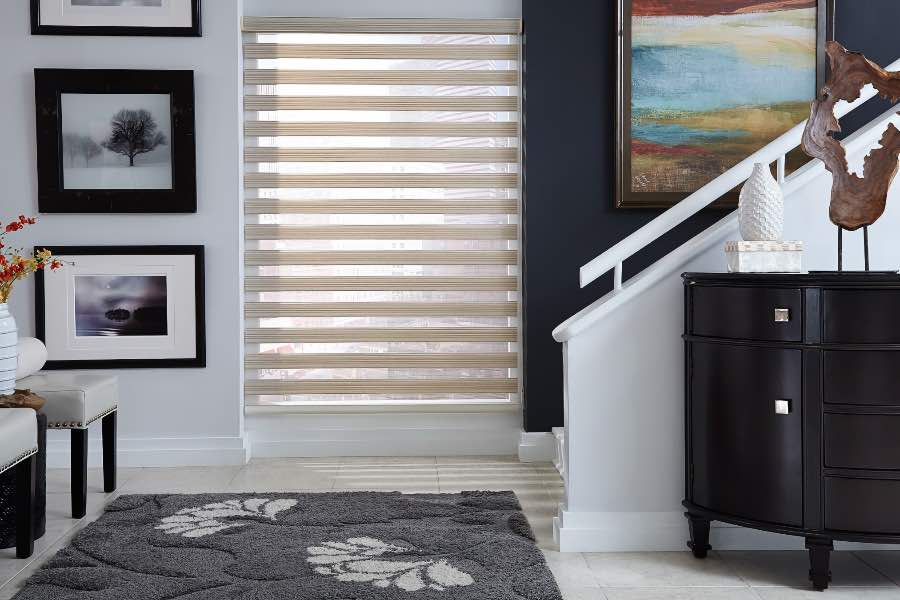 Zebra shade lets in light from a window near a staircase