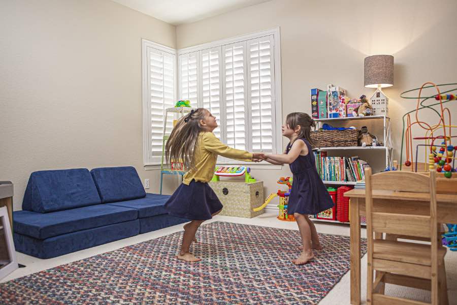 Choose Polywood shutters for durable, kid-friendly great room window treatments in Bluff City. Polywood shutters on multiple windows in a sitting area