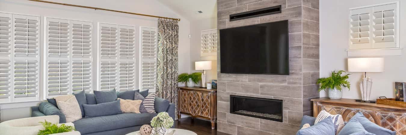 Plantation shutters in Johnson City family room with fireplace