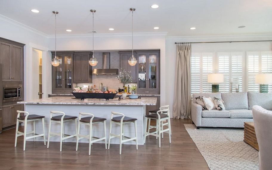 White arched shutters in a white kitchen with lots of light.