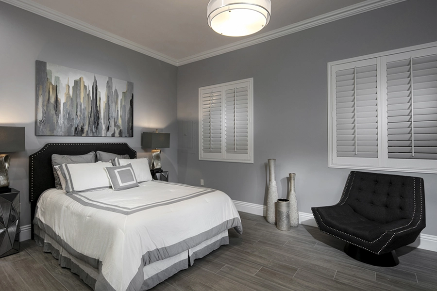 Close your custom Polywood shutters to beat the heat and keep your Bluff City bedroom cool. White Polywood shutters on bedroom windows