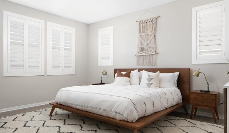 Open shutter louvers will help any Bluff City room feel larger. Plantation shutters in a model home bedroom.