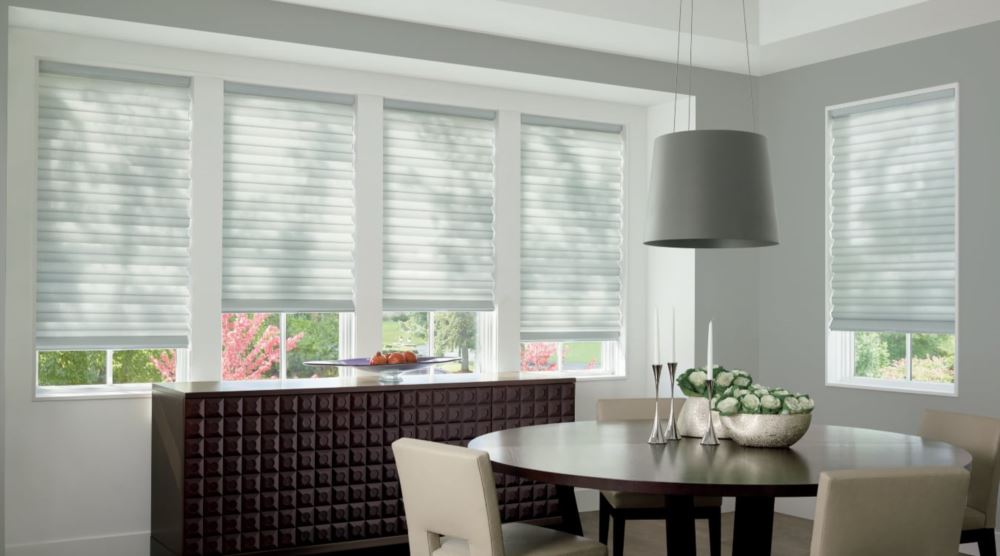 Custom cordless roller shades have a clean look and are appropriate for any room. Cordless motorized shades in a Bluff City dining room