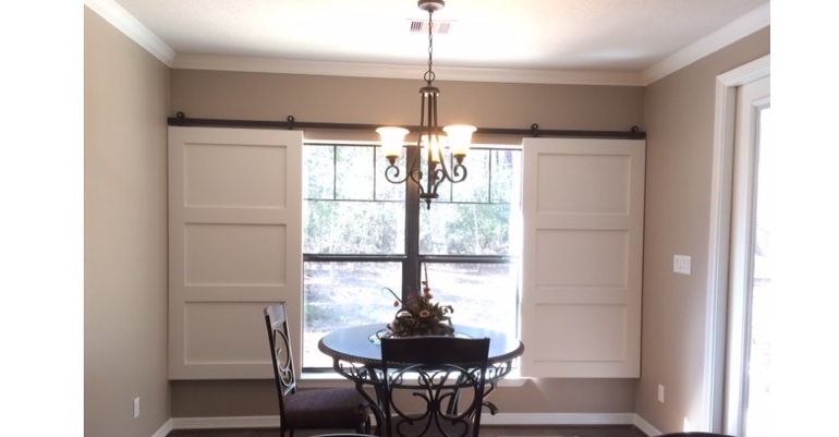 Barn doors open horizontally with slides instead of cords. Bluff City barn door shutters