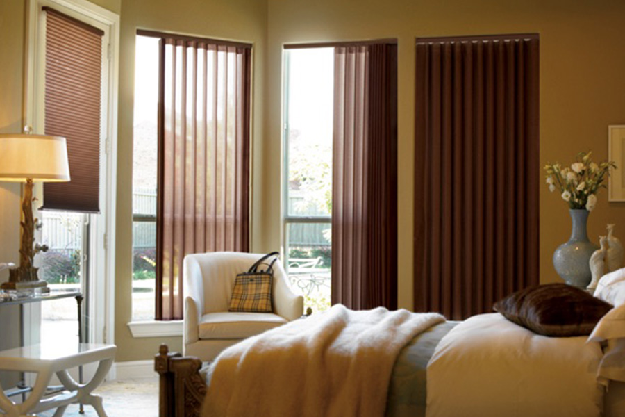 Choose durable and high-quality fabric or vinyl vertical blinds in Bluff City. Maroon fabric vertical blinds inside a bedroom