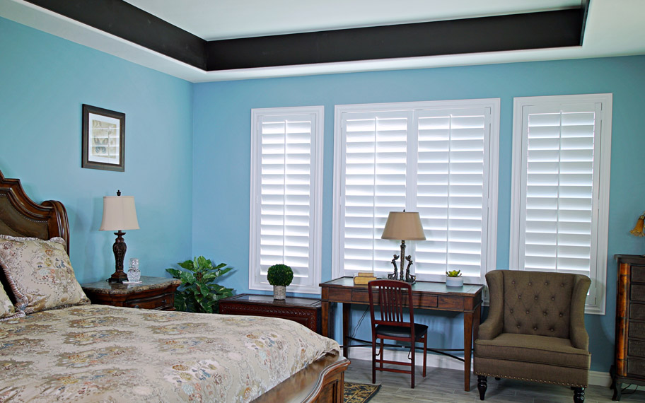 Polywood shutters provide insulation for the perfect temperature all year long in Bluff City. Polywood shutters in a bedroom.