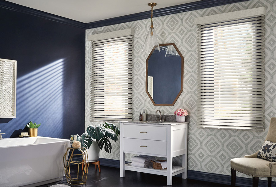 Faux-wood blinds can add a clean, crisp touch to any bathroom. Bathroom window with faux-wood blinds for privacy and light control.