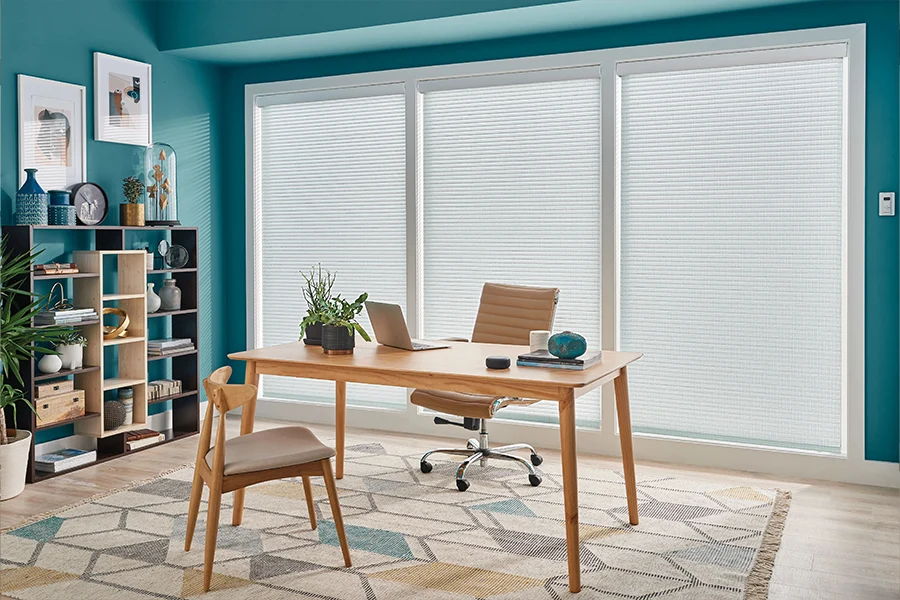 The easier it is to adjust your home office window treatment for sunlight, the easier it is to do your best work. White sheer shades on large windows in a home office