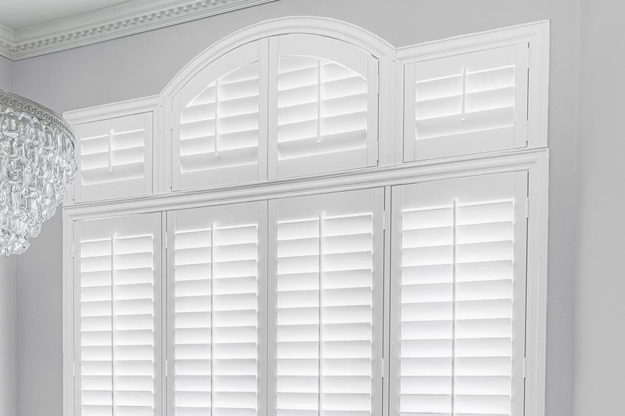 Customize your Palladian windows with white Polywood shutters in Bluff City. White Polywood Palladian windows in a dining room.