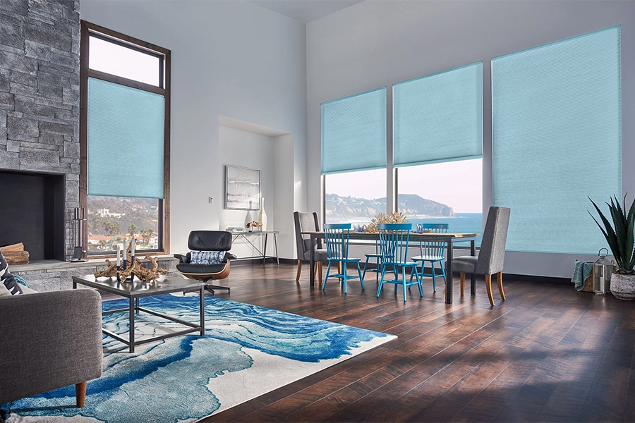 Smart motorized window shades are perfect on tall windows in your Bluff City home. Blue motorized shades on tall living room windows